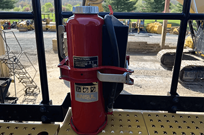 A Class D Fire Extinguisher By Ansul Against A Background Of Construction Equipment 1